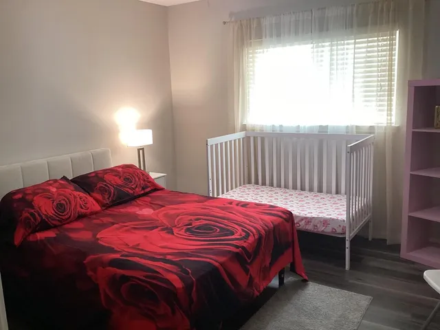 a bedroom with a bed and a window