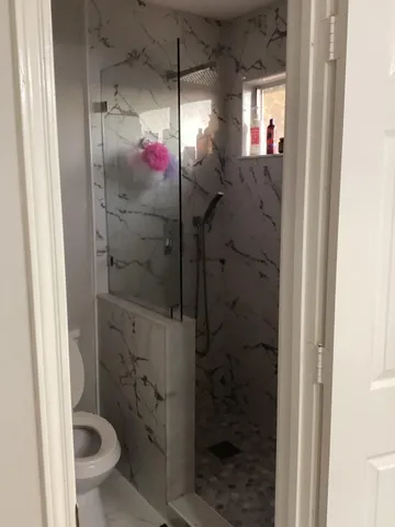 a bathroom with a shower and a toilet