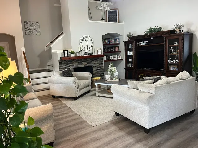 a living room with furniture and a fireplace