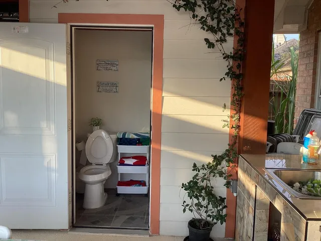 a bathroom with a toilet and a shower curtain