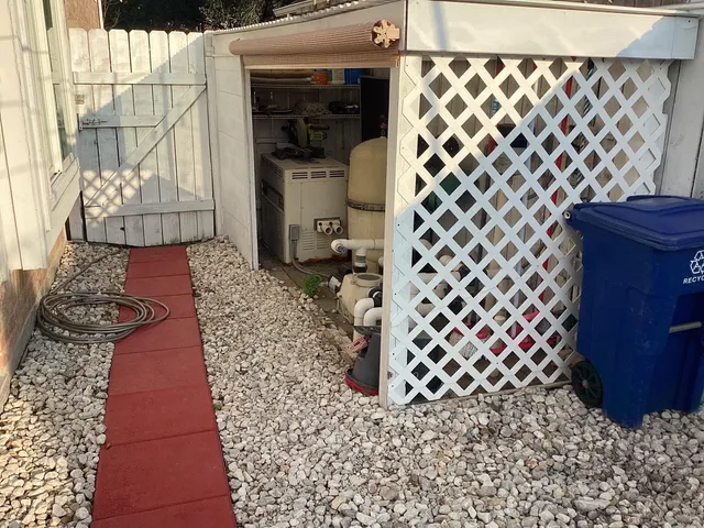 a room with a wooden floor a wall clock and a large window