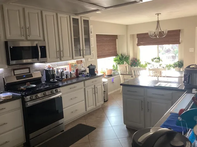 a kitchen with stainless steel appliances a stove sink and cabinets