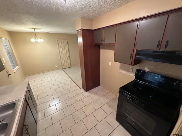 a kitchen with a sink and a refrigerator