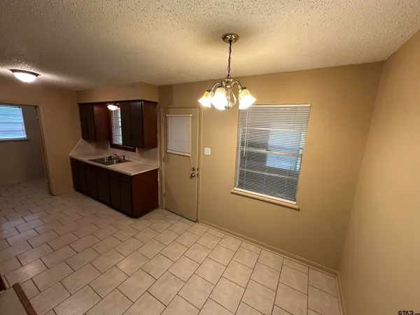 a kitchen with stainless steel appliances a stove a sink and a refrigerator