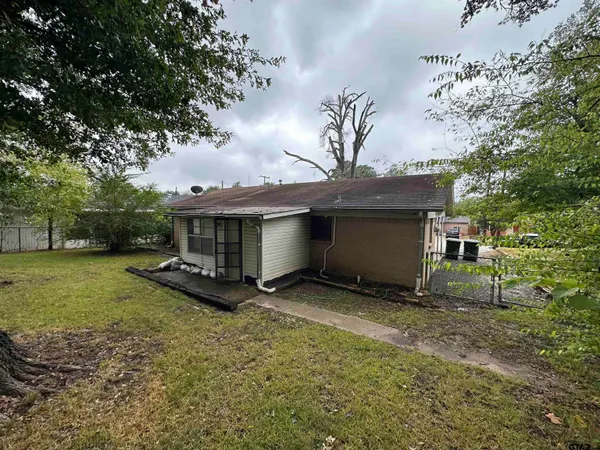 a view of a house with a yard and tree