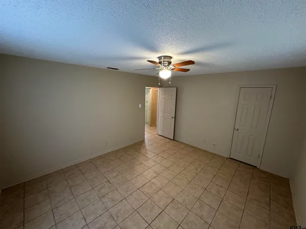 a view of an empty room with a fan