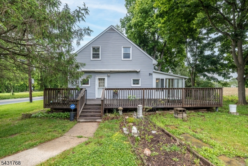400 Mechlin Corner Road Pittstown, NJ 08867 - Photo 1 of 29 a view of a house with a backyard and wooden fence