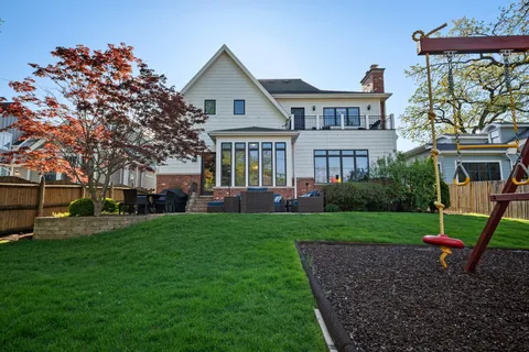 an aerial view of a house with garden space and street view