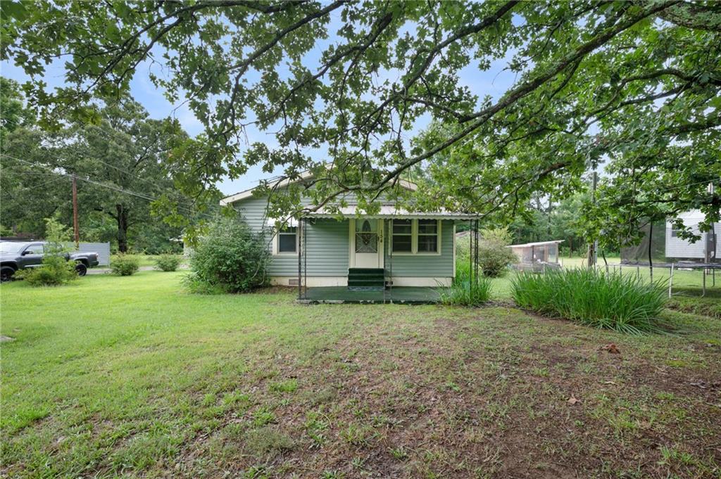 154 County Line Road Southwest Plainville, GA 30733 - Photo 1 of 27 a view of a house with yard and a tree