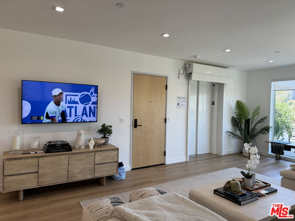 9842 Vidor Drive, Unit 402 Los Angeles, CA 90035 - Photo 11 of 23 a living room with furniture and wooden floor