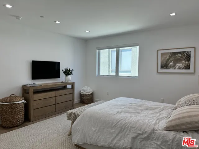 a bedroom with bed and tv