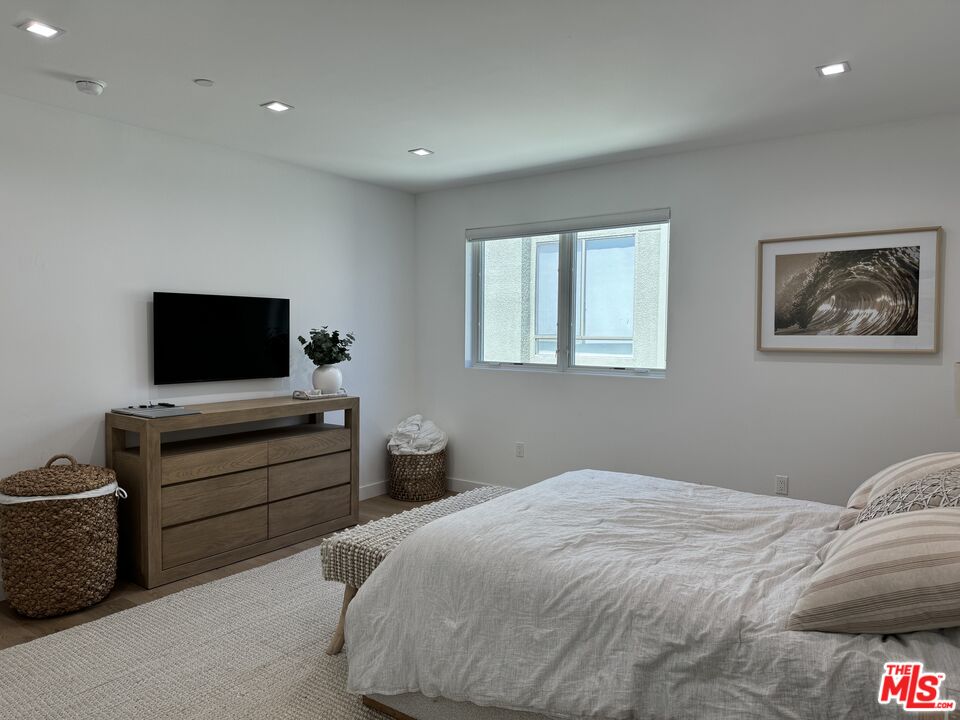 9842 Vidor Drive, Unit 402 Los Angeles, CA 90035 - Photo 12 of 23 a bedroom with bed and tv