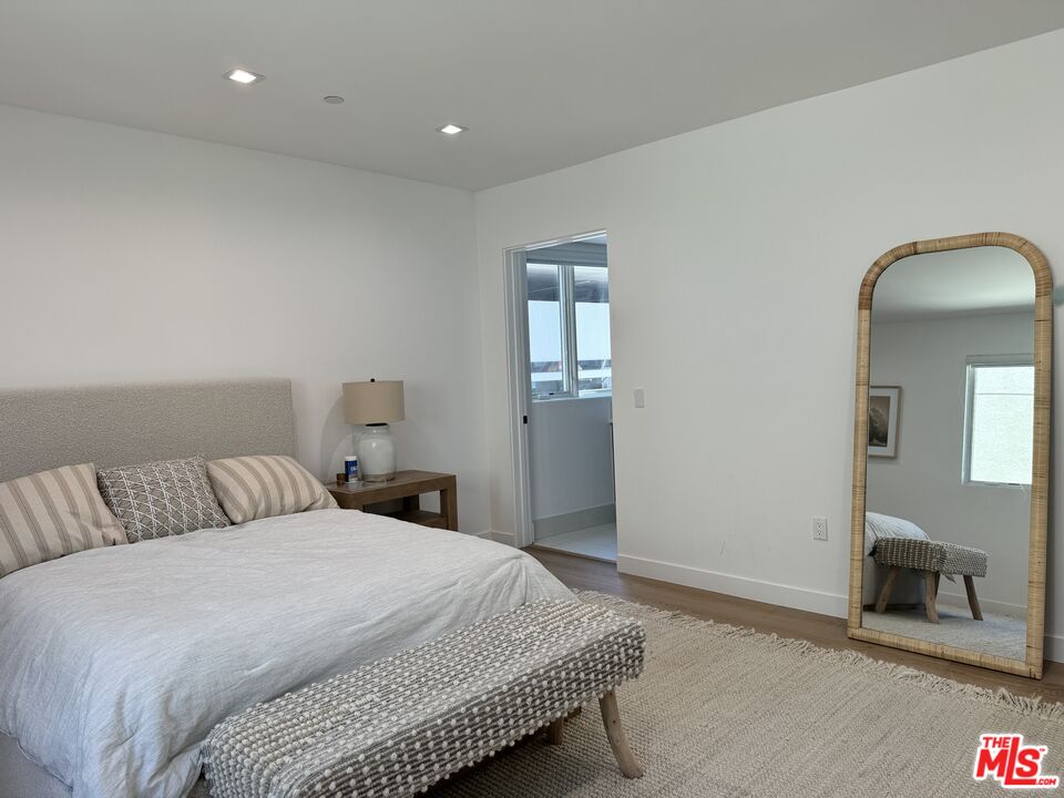 9842 Vidor Drive, Unit 402 Los Angeles, CA 90035 - Photo 15 of 23 a bedroom with a bed and a couch