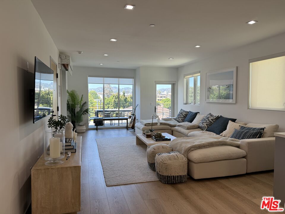 9842 Vidor Drive, Unit 402 Los Angeles, CA 90035 - Photo 2 of 23 a living room with furniture and a flat screen tv