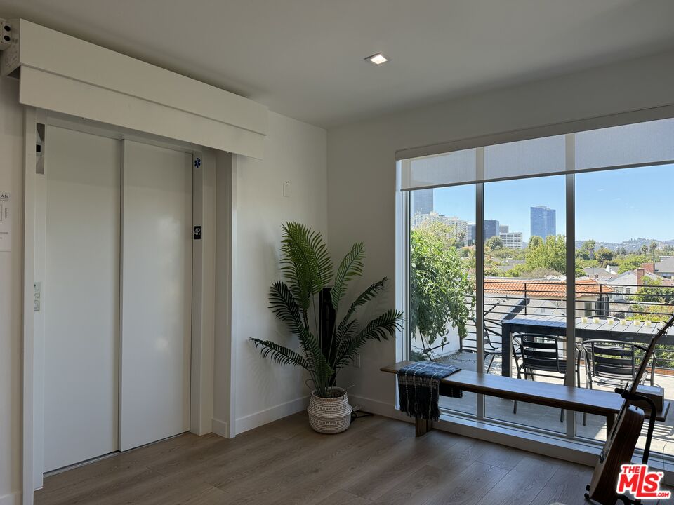 9842 Vidor Drive, Unit 402 Los Angeles, CA 90035 - Photo 21 of 23 a living room with furniture and a potted plant