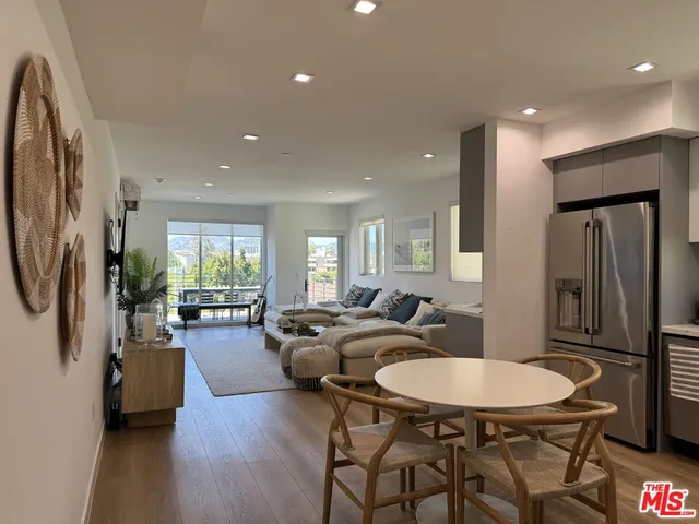 a view of a a dining room with furniture window and wooden floor