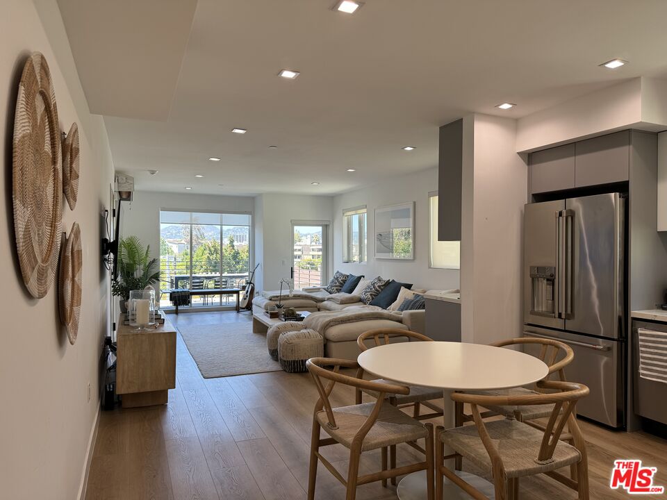 9842 Vidor Drive, Unit 402 Los Angeles, CA 90035 - Photo 4 of 23 a view of a a dining room with furniture window and wooden floor