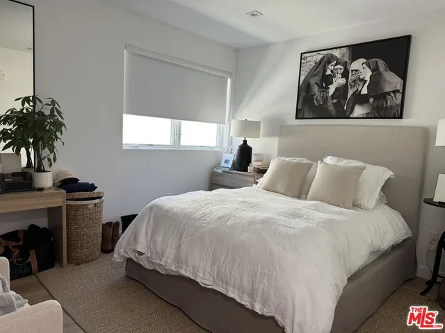 a bedroom with bed and window