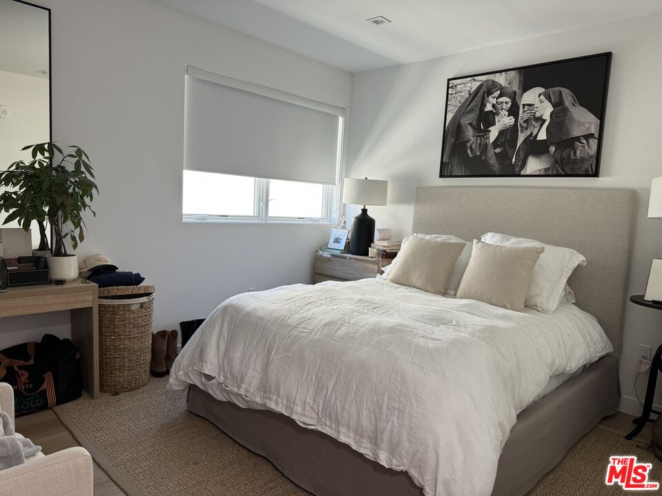 9842 Vidor Drive, Unit 402 Los Angeles, CA 90035 - Photo 5 of 23 a bedroom with bed and window