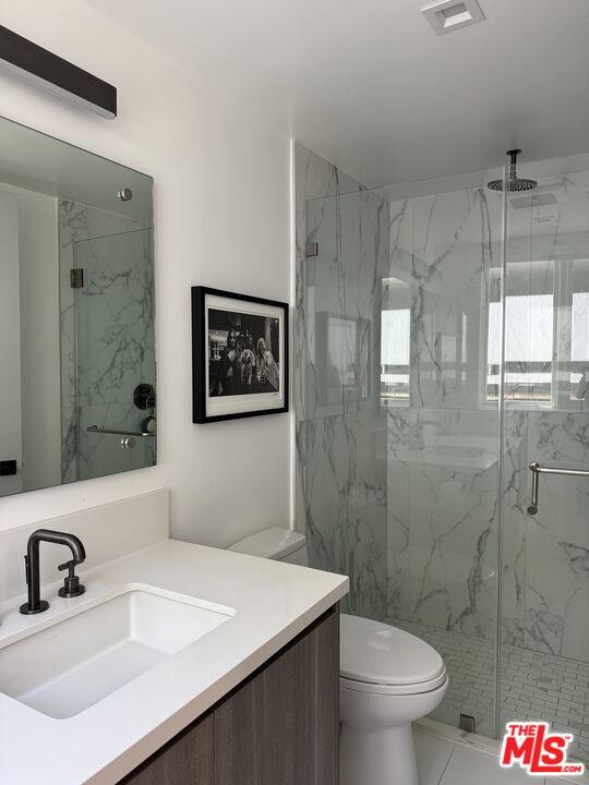 9842 Vidor Drive, Unit 402 Los Angeles, CA 90035 - Photo 7 of 23 a bathroom with a sink a toilet and shower