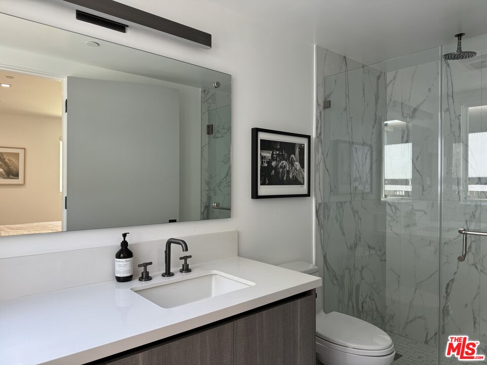 9842 Vidor Drive, Unit 402 Los Angeles, CA 90035 - Photo 8 of 23 a bathroom with a sink a toilet and shower
