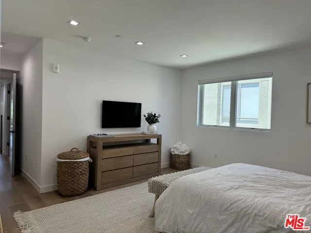a bedroom with a bed and a television