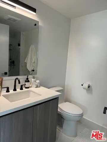 a bathroom with a sink a toilet and a mirror
