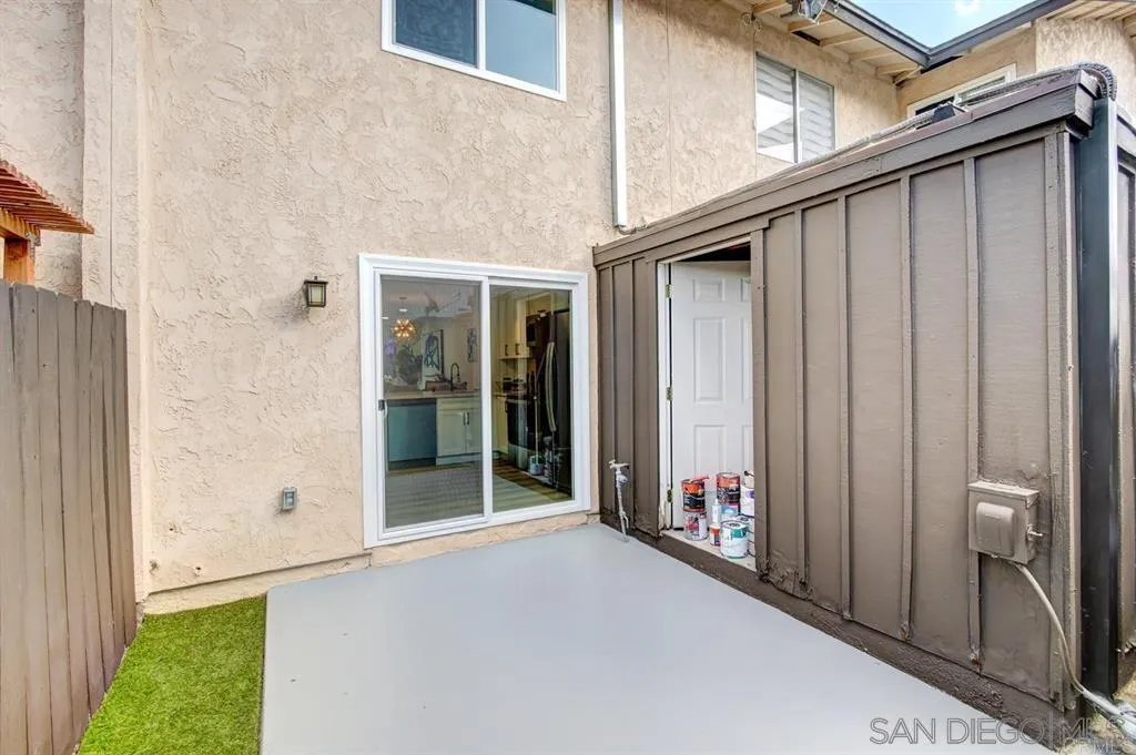 a backyard of a house with wooden floor and entryway