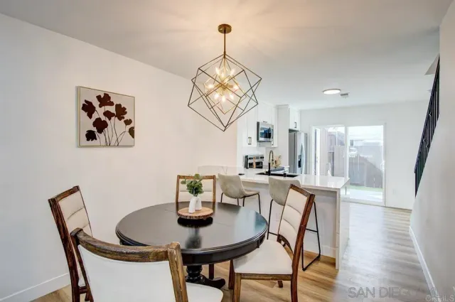 a view of a dining room with furniture wooden floor and a chandelier