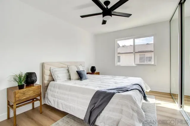 a bedroom with a bed and wooden floor