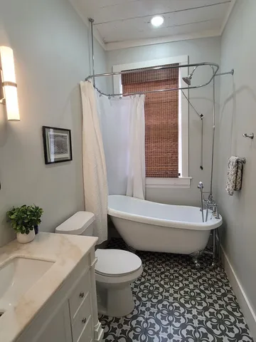 a bathroom with a toilet a sink and bathtub