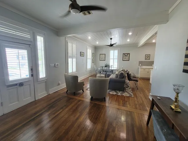 a living room with furniture or wooden floor and a large window
