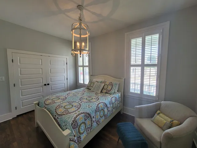 a bedroom with a bed and window