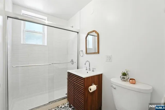 a bathroom with a sink toilet and a mirror