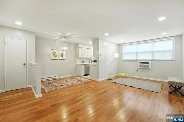 a room with a bed and a view of kitchen