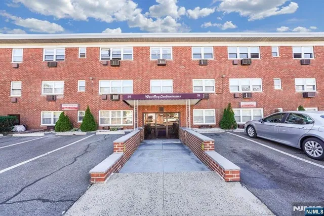 a front view of a building with parking space