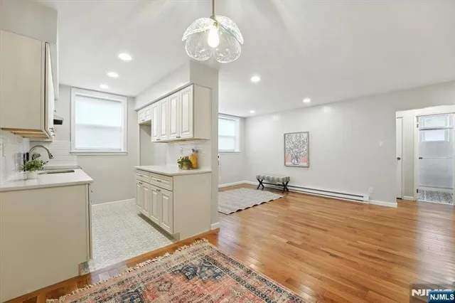 a open kitchen with sink cabinets and wooden floor
