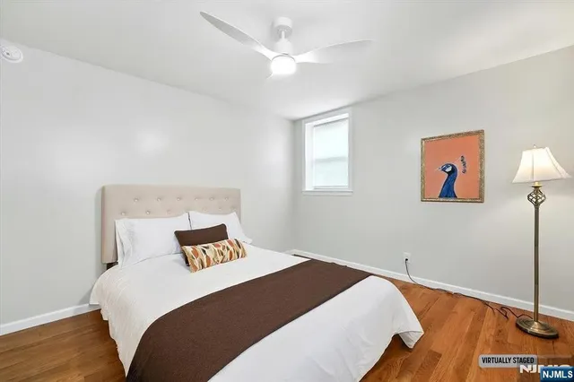 a bedroom with a bed and a painting on the wall