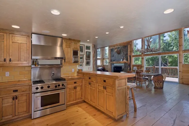 a large kitchen with stainless steel appliances granite countertop a stove and a refrigerator