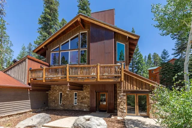 a front view of a house with a yard covered in snow