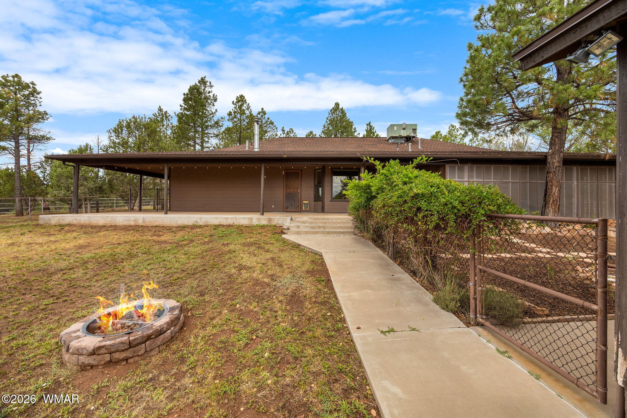 1955 Ricochet Ranch Road Overgaard, AZ 85933 - Photo 28 of 48 a front view of a house with a yard