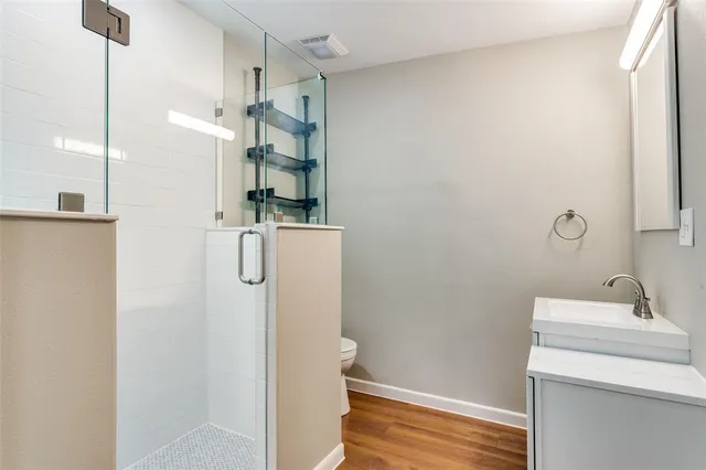 a bathroom with a toilet and a shower