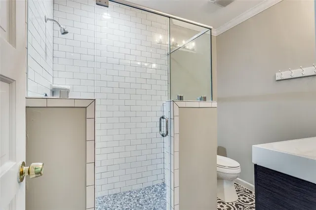 a view of a room with windows and chandelier fan