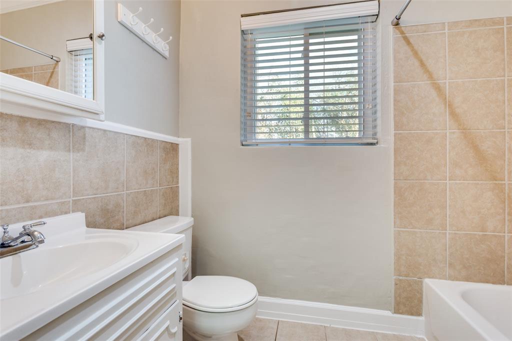 4045 Carolyn Road Fort Worth, TX 76109 - Photo 24 of 28 a bathroom with a sink a toilet and shower