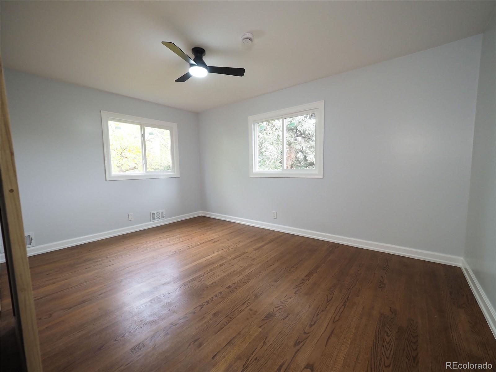 6751 South Downing Circle West Centennial, CO 80122 - Photo 11 of 34 a view of an empty room with wooden floor and a window