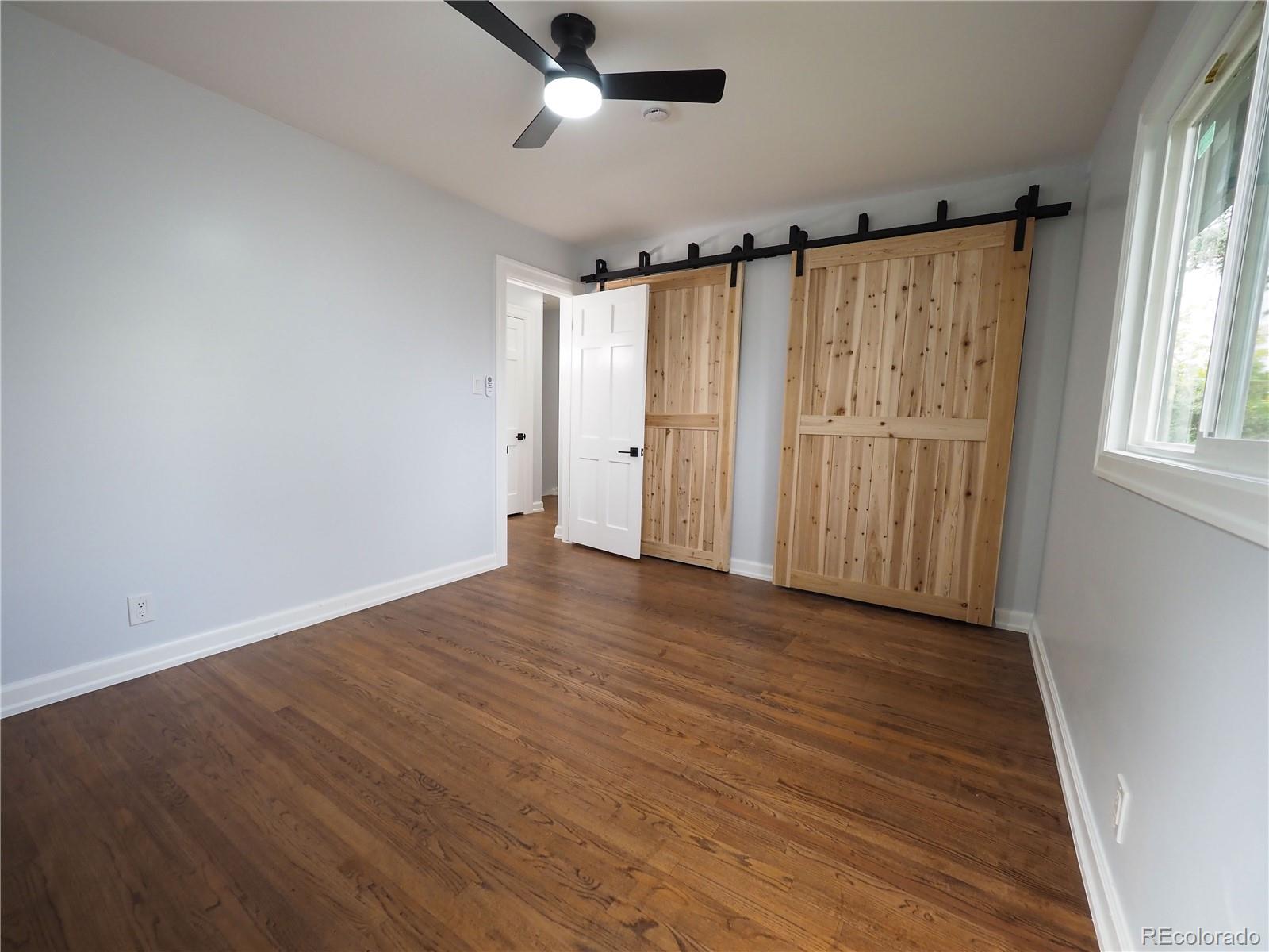 6751 South Downing Circle West Centennial, CO 80122 - Photo 13 of 34 an empty room with wooden floor fan and windows