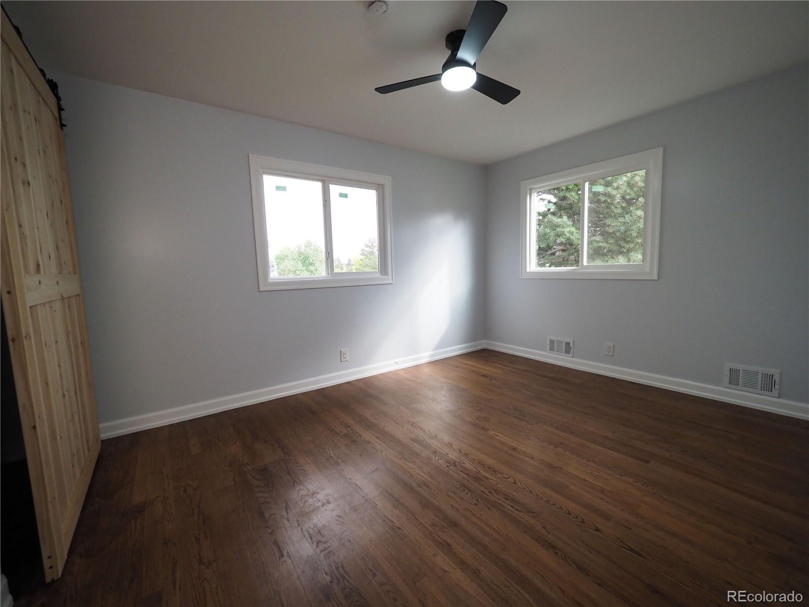 6751 South Downing Circle West Centennial, CO 80122 - Photo 16 of 34 a view of an empty room with wooden floor and a window