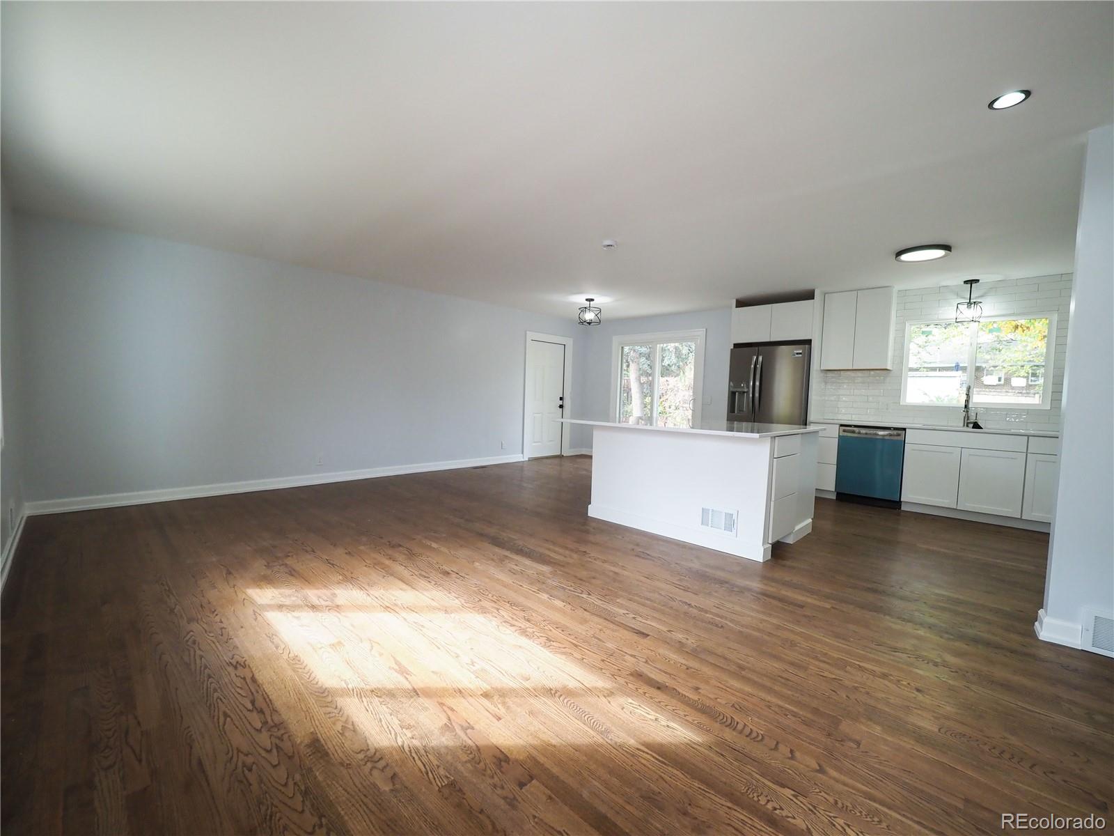 6751 South Downing Circle West Centennial, CO 80122 - Photo 3 of 34 a view of a kitchen with a sink and a microwave
