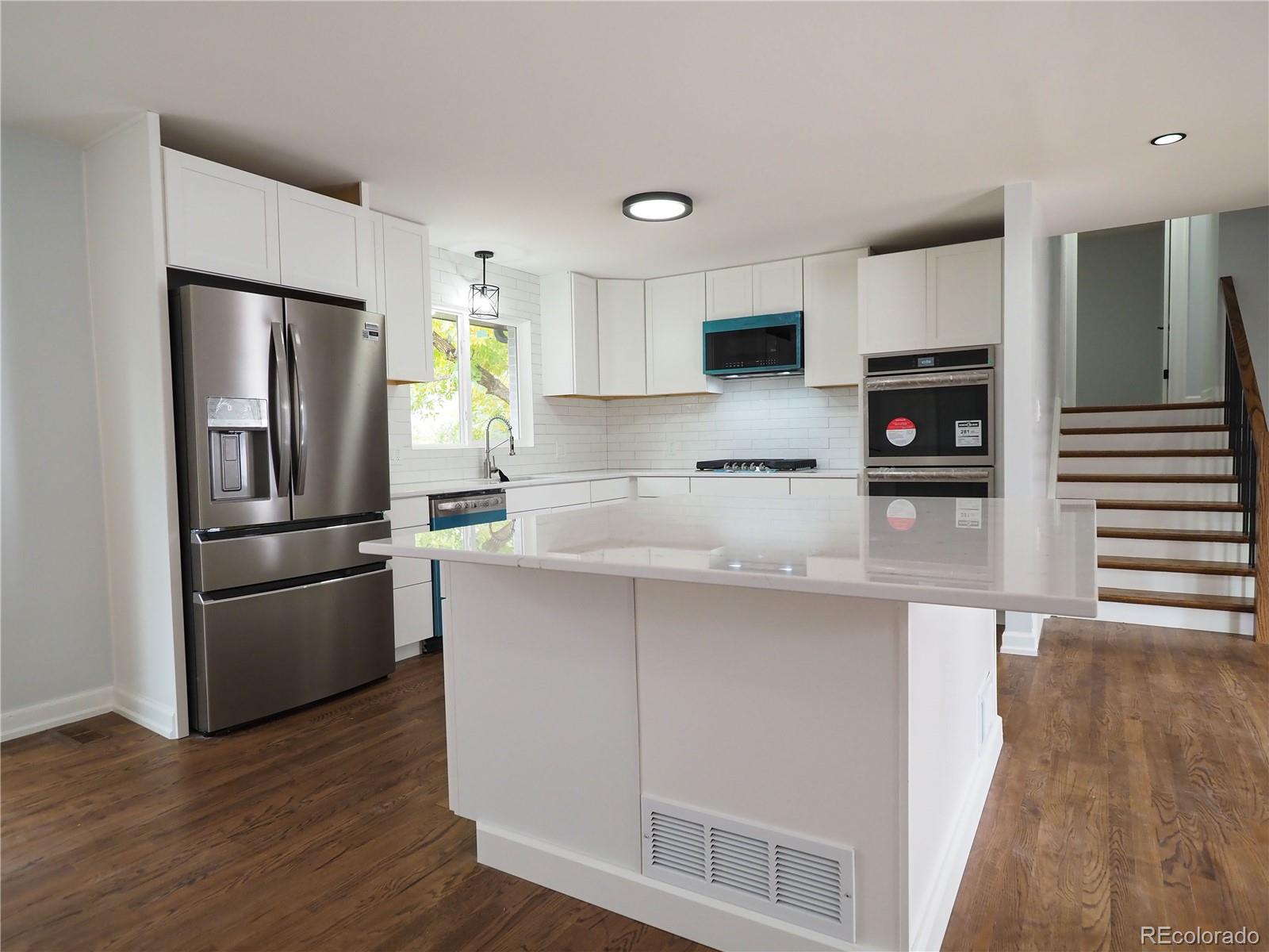 6751 South Downing Circle West Centennial, CO 80122 - Photo 4 of 34 a kitchen with stainless steel appliances a refrigerator and a stove top oven