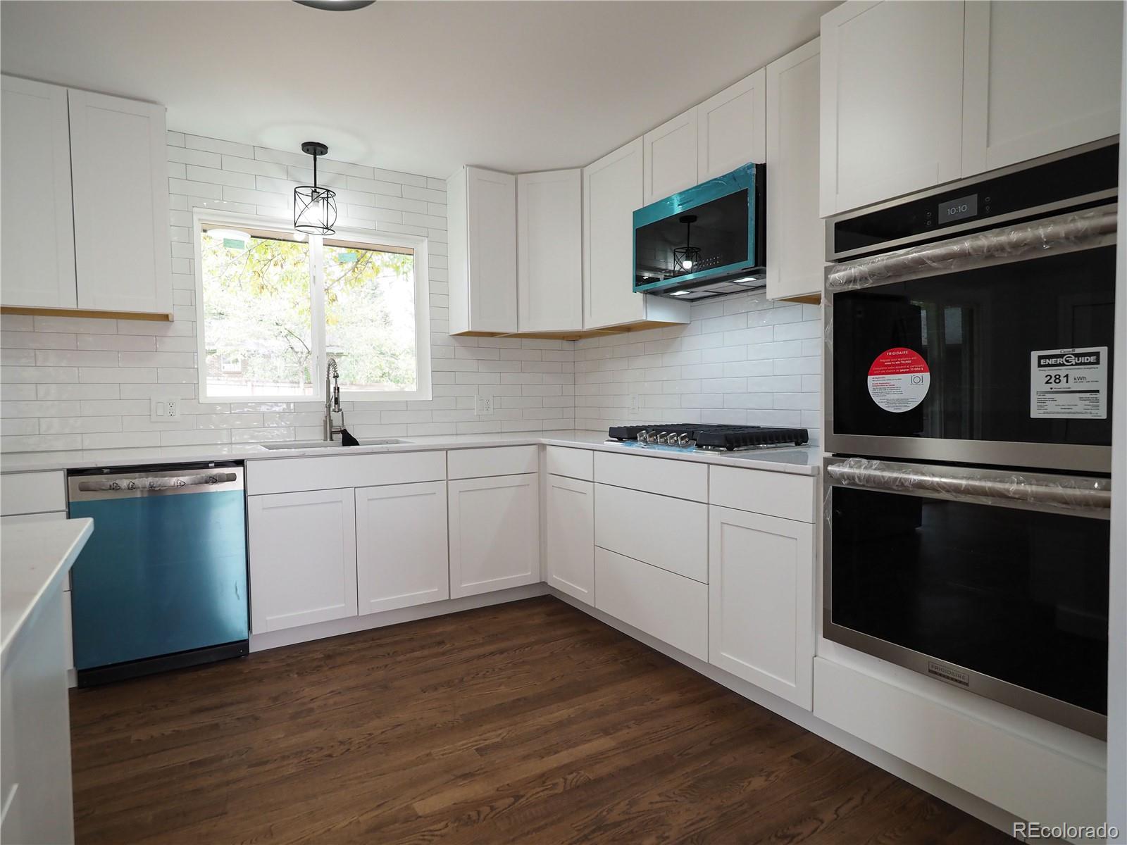 6751 South Downing Circle West Centennial, CO 80122 - Photo 5 of 34 a kitchen with a sink stove and microwave